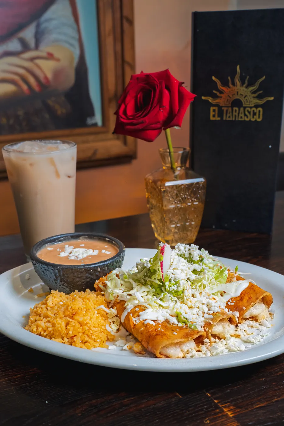 Rolled tacos with Mexican rice, creamy salsa and a glass of horchata